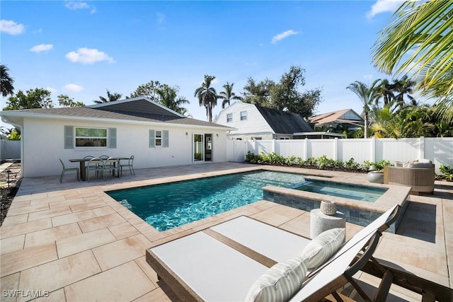 view of pool with a patio area and an in ground hot tub