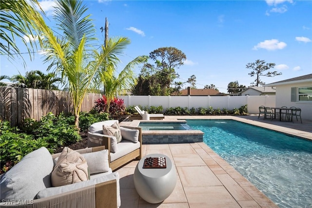 view of pool with a patio area and an in ground hot tub