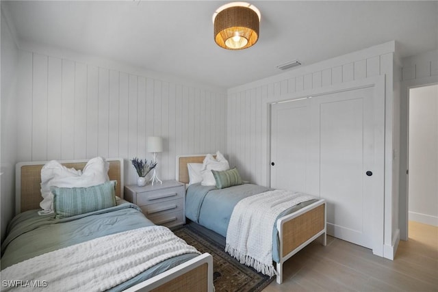 bedroom with wood-type flooring and a closet