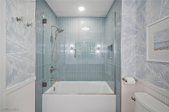 bathroom with toilet and enclosed tub / shower combo