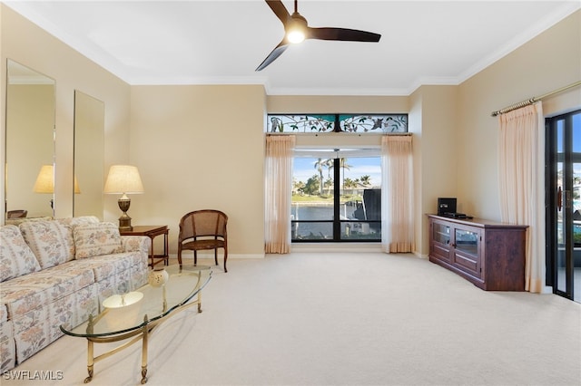 carpeted living room with crown molding, a water view, and ceiling fan