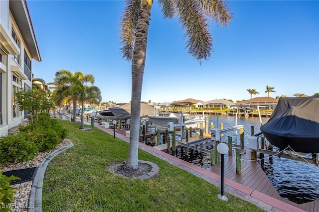 view of dock featuring a yard and a water view