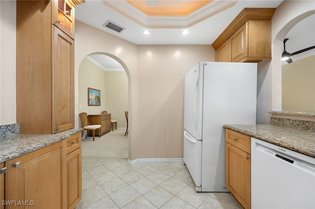 kitchen featuring light carpet, light stone counters, white appliances, ceiling fan, and crown molding