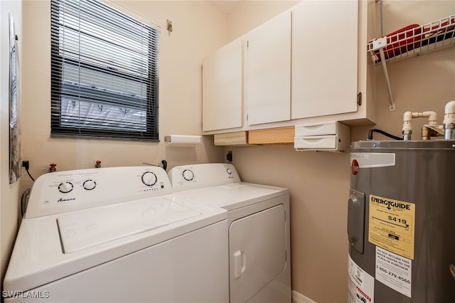 clothes washing area with cabinets, electric water heater, and washer and clothes dryer