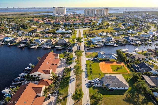 aerial view at dusk featuring a water view