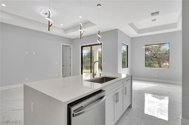 kitchen featuring stainless steel dishwasher, a raised ceiling, white cabinetry, and sink