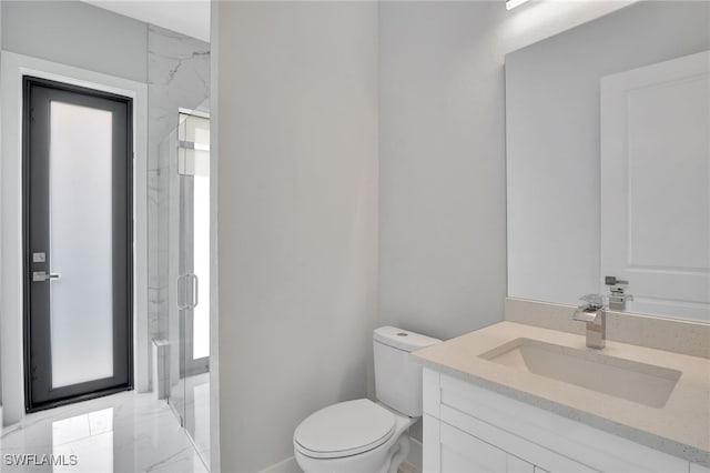 bathroom featuring an enclosed shower, vanity, toilet, and plenty of natural light