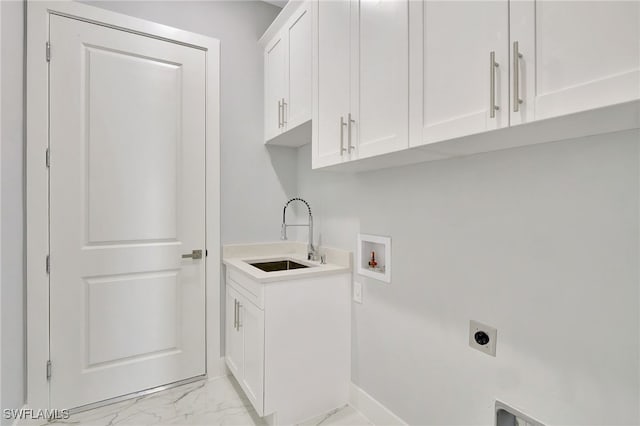 washroom with hookup for an electric dryer, hookup for a washing machine, cabinets, and sink