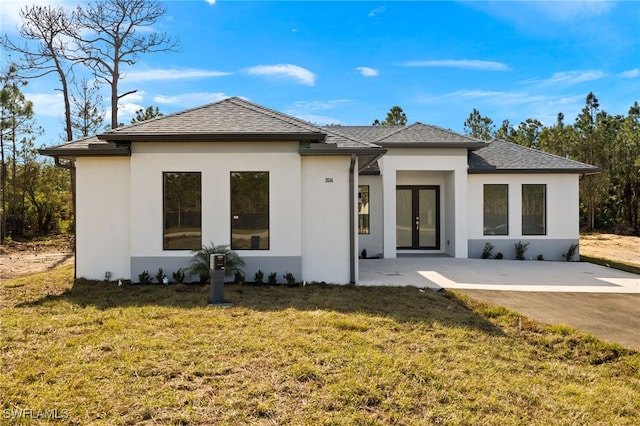 back of house featuring a yard, a patio, and french doors