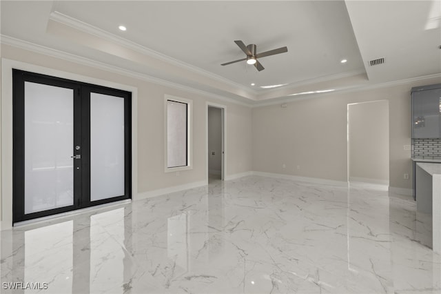 spare room featuring ceiling fan, french doors, crown molding, and a tray ceiling