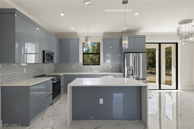 kitchen with backsplash, crown molding, pendant lighting, and stainless steel appliances