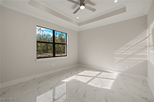 spare room featuring ceiling fan, crown molding, and a tray ceiling