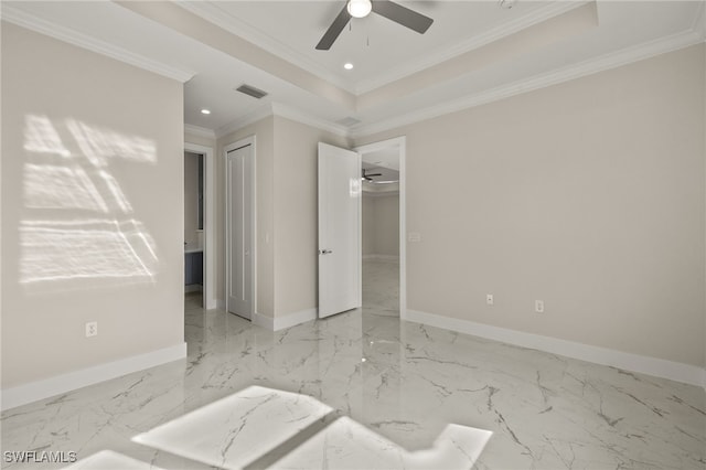 spare room featuring a tray ceiling, ceiling fan, and ornamental molding