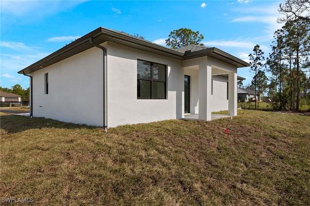 rear view of house with a lawn