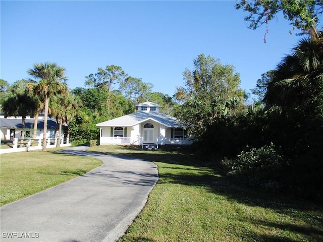 ranch-style house with a porch and a front lawn