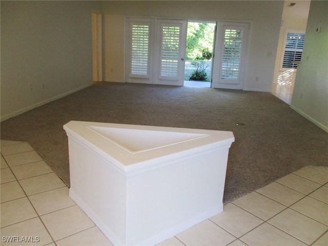 unfurnished living room featuring light carpet