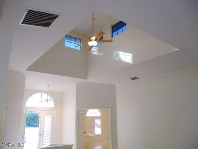 room details with ceiling fan with notable chandelier