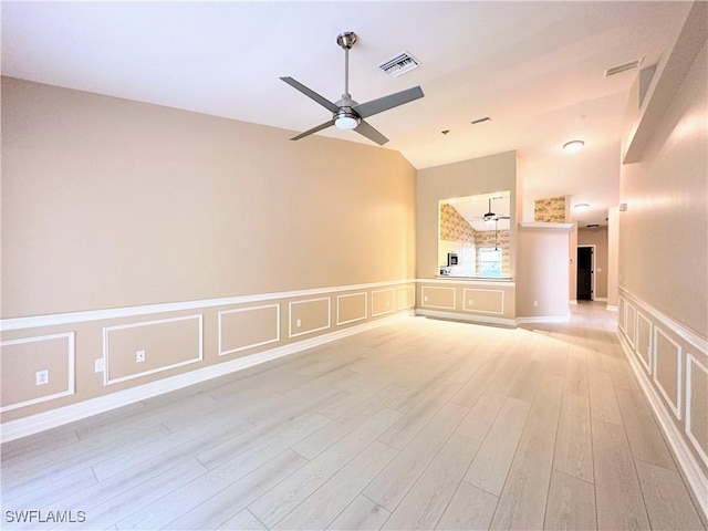 unfurnished living room with light wood-type flooring, ceiling fan, and lofted ceiling