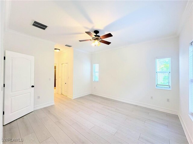 spare room featuring ceiling fan, ornamental molding, and light hardwood / wood-style flooring