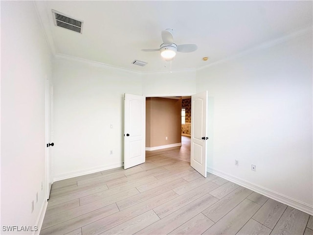 spare room with ceiling fan, light hardwood / wood-style floors, and crown molding