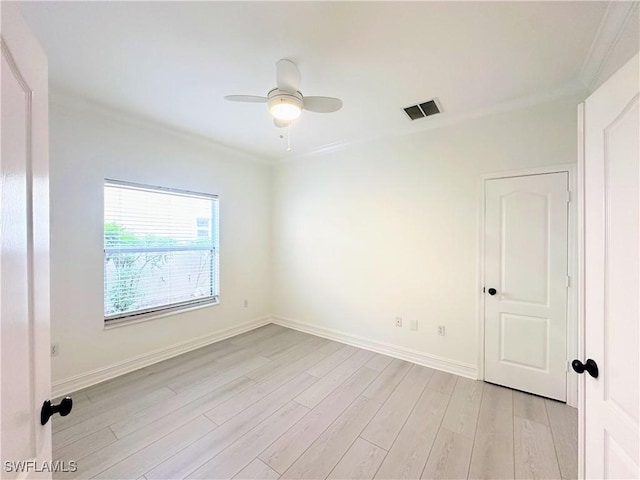 spare room with ceiling fan, light hardwood / wood-style floors, and ornamental molding