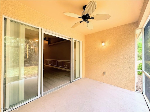 unfurnished sunroom with ceiling fan and plenty of natural light