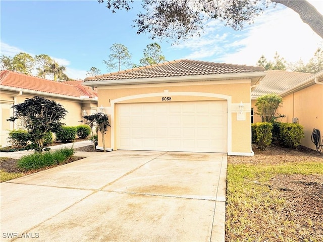 mediterranean / spanish-style house with a garage