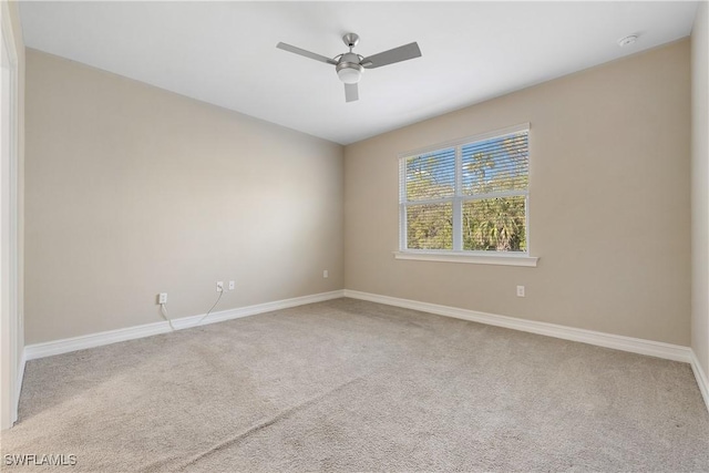 carpeted spare room featuring ceiling fan