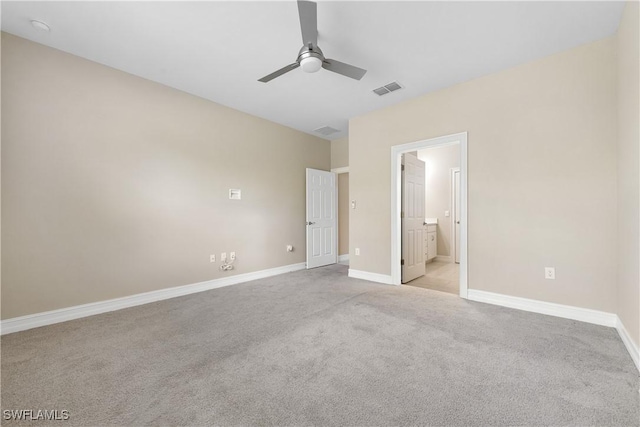 unfurnished bedroom with light carpet, ceiling fan, and connected bathroom