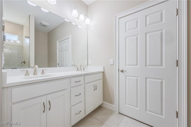 bathroom featuring vanity, tile patterned flooring, and walk in shower