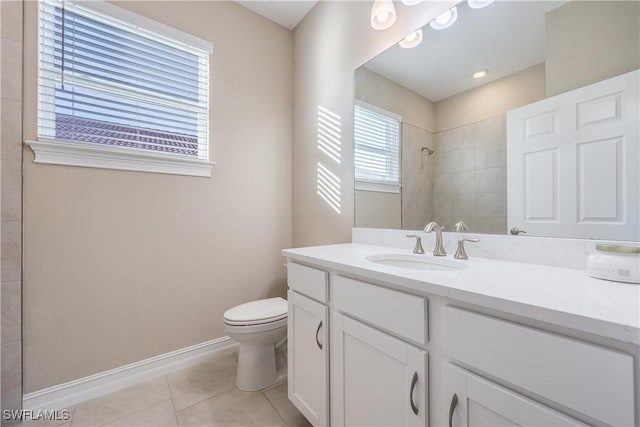 bathroom featuring toilet, tile patterned flooring, tiled shower, and vanity