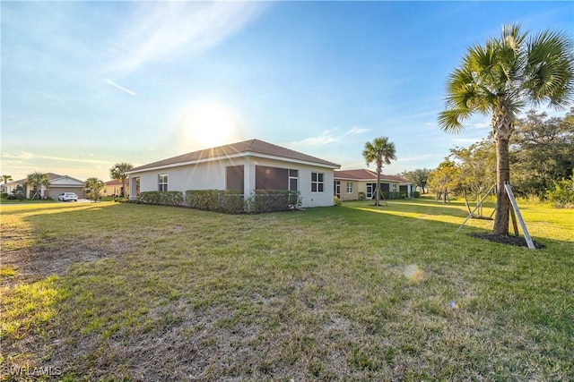 view of side of home with a lawn