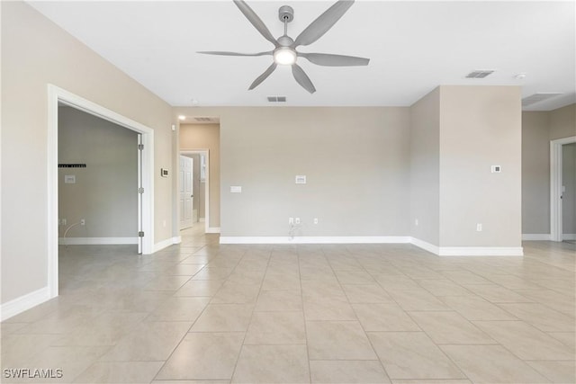 tiled spare room featuring ceiling fan