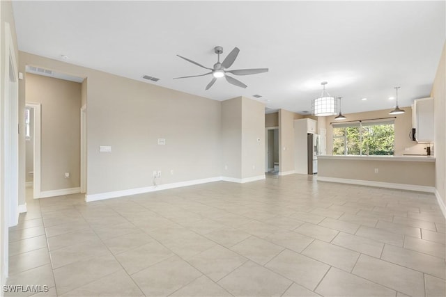 unfurnished living room with ceiling fan and light tile patterned floors