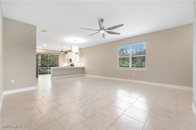 unfurnished living room featuring ceiling fan and light tile patterned floors