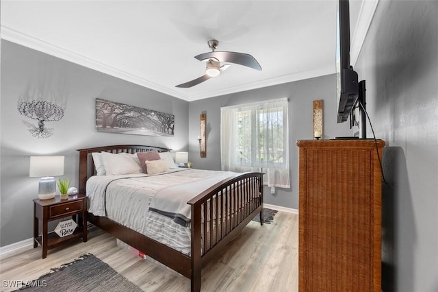 bedroom featuring ceiling fan, light wood-type flooring, and ornamental molding