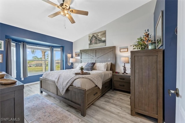 bedroom featuring ceiling fan, light hardwood / wood-style floors, and vaulted ceiling