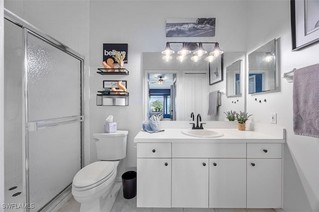 bathroom with walk in shower, vanity, toilet, and ceiling fan