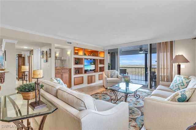 living area featuring ornamental molding, visible vents, and built in features