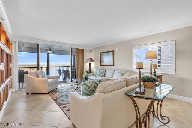 living area with light tile patterned floors, ornamental molding, expansive windows, and baseboards