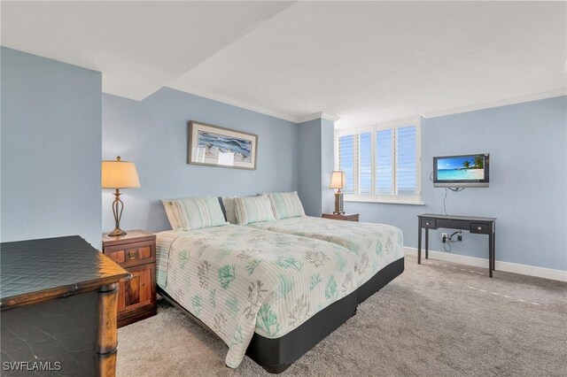 bedroom featuring baseboards, ornamental molding, and light colored carpet