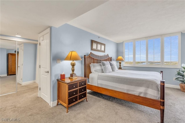 bedroom featuring baseboards and light colored carpet