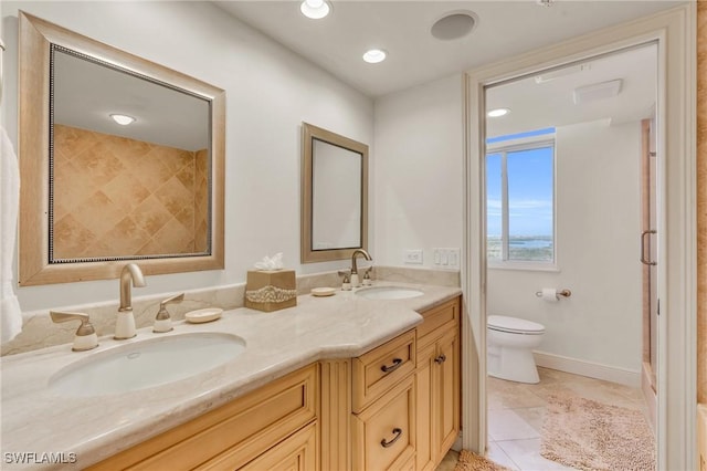 full bath with tile patterned flooring, a sink, toilet, and double vanity