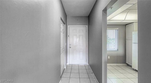 hall featuring light tile patterned floors