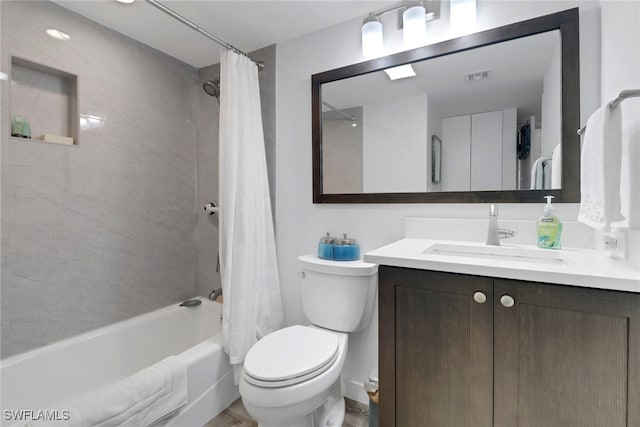 full bathroom featuring vanity, toilet, and shower / tub combo