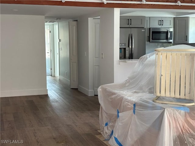 interior space with gray cabinetry, dark hardwood / wood-style flooring, and appliances with stainless steel finishes