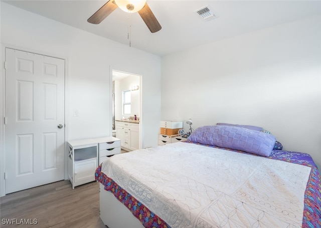 bedroom with ceiling fan, connected bathroom, and light hardwood / wood-style flooring