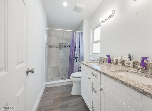 bathroom featuring a shower with shower curtain, vanity, toilet, and hardwood / wood-style flooring