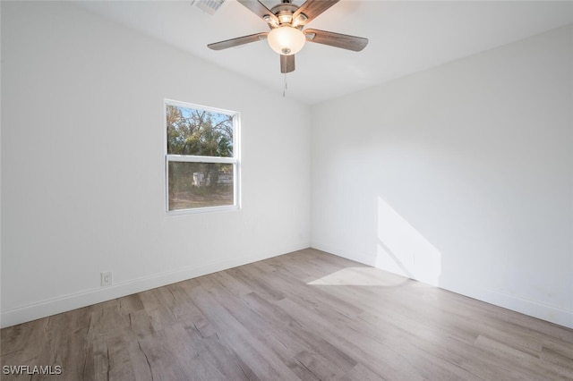 spare room with lofted ceiling, ceiling fan, and light wood-type flooring