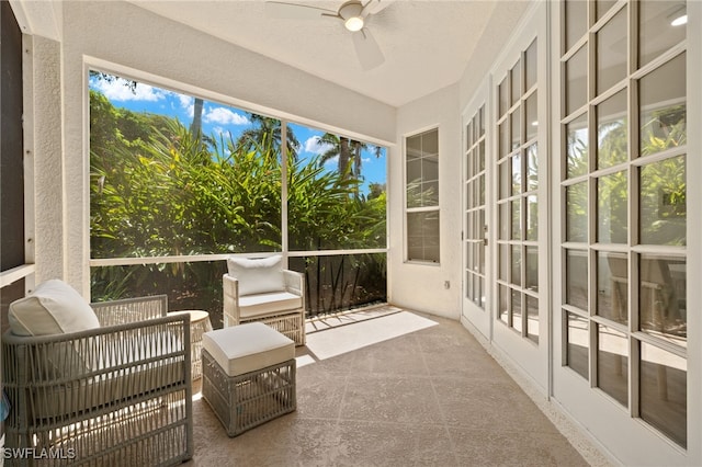 sunroom featuring ceiling fan